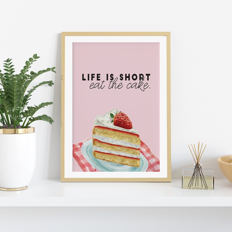 May include: A pink and white printable wall art print with the text "LIFE IS SHORT eat the cake." and a watercolor illustration of a slice of strawberry cake.
