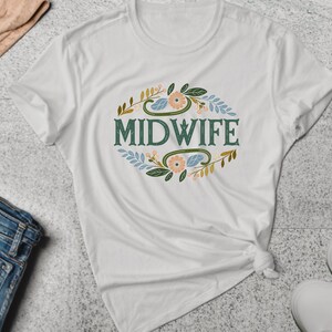 May include: White t-shirt with a green floral design and the word "MIDWIFE" in green text.