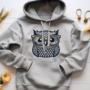 May include: A gray hooded sweatshirt with a graphic print of an owl wearing glasses. The owl is black and white with gold-colored glasses.