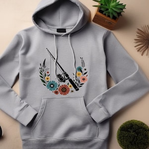 May include: A gray hooded sweatshirt with a floral design featuring a fishing rod and reel. The flowers are in shades of pink, blue, yellow, and orange.