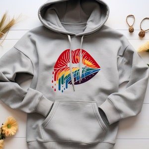 May include: A gray hoodie with a rainbow-colored dripping lips design on the front.