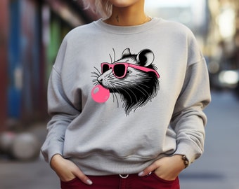 May include: A gray sweatshirt with a graphic of a rat wearing pink sunglasses and blowing a pink bubble.