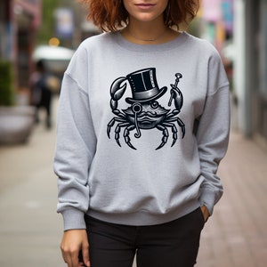 May include: A gray sweatshirt with a black and white illustration of a crab wearing a top hat and monocle. The crab is holding a cane in one claw.