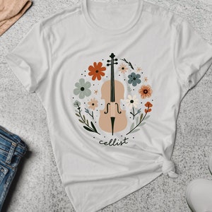 May include: White t-shirt with a floral design featuring a cello and the word "cellist".