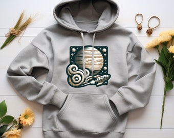 May include: A gray hoodie with a graphic print of a rocket flying past a planet with rings. The planet is surrounded by stars and the rocket is leaving a trail of smoke.