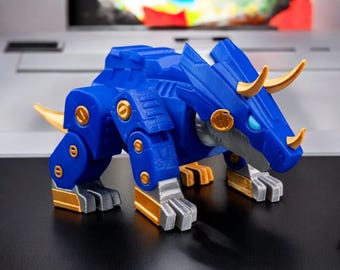 May include: A blue and gold robotic dinosaur toy with articulated legs and a horned head. The toy is made of plastic and has a detailed design.