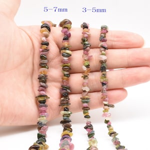 May include: Five strands of multi-colored chip gemstone beads, ranging in size from 3-5mm to 5-7mm. The beads are a mix of pink, green, brown, and black.