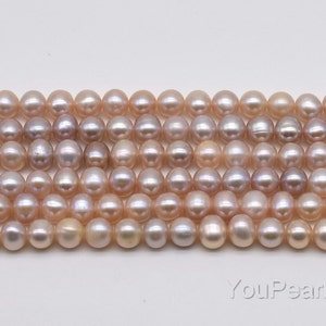 May include: A strand of light pink freshwater pearls with a slight iridescent sheen. The pearls are round and smooth, and they are strung on a white thread.