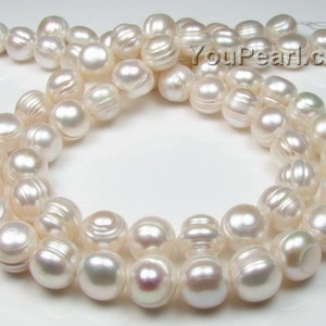 May include: A strand of white freshwater pearls with a slightly off-white hue. The pearls are round and have a smooth, glossy finish. The pearls are strung on a white thread and are approximately 8mm in diameter. YouPearl.com is printed on the background.