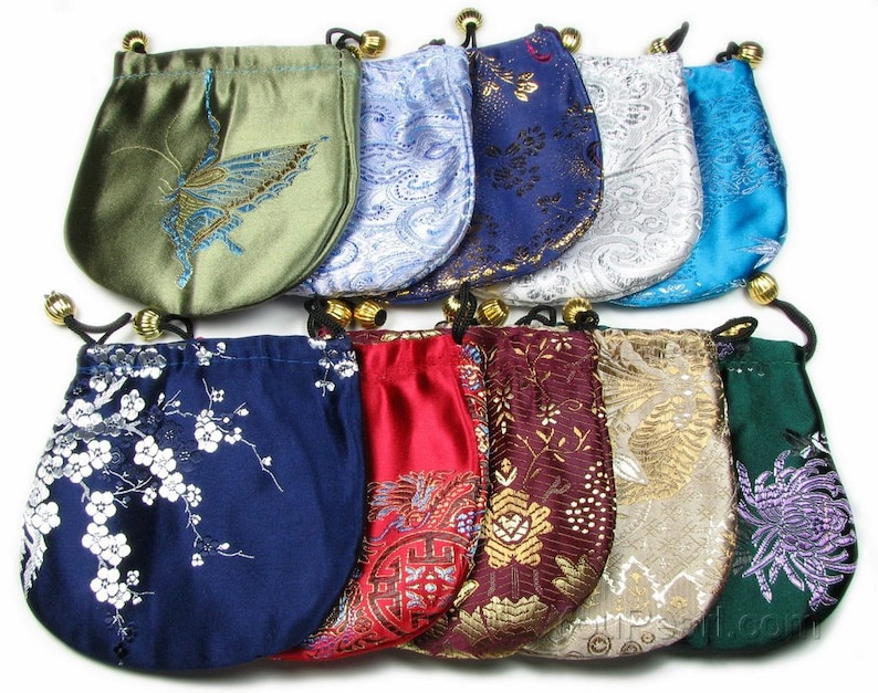 May include: Assortment of ten small drawstring bags in various colors and patterns. The bags are made of satin and feature embroidered designs, including butterflies, flowers, and geometric patterns.