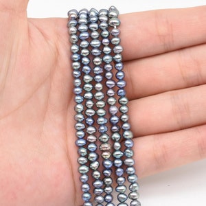 May include: A strand of gray freshwater pearls, approximately 5mm in size, strung on a thin thread. The pearls have a slightly iridescent sheen.