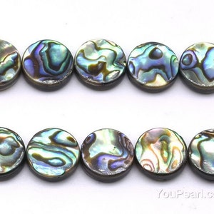 May include: A strand of round, iridescent abalone shell beads. The beads have a dark brown backing and feature a swirling pattern of green, blue, and gold.
