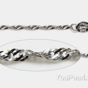 May include: A silver chain necklace with a twisted rope design and a lobster clasp. The chain is marked "925 Italy".