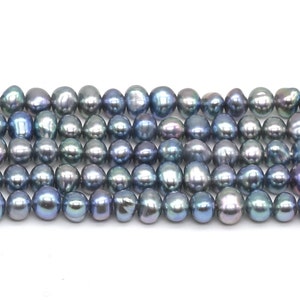 May include: A strand of iridescent blue freshwater pearls. The pearls are round and have a smooth, glossy finish.