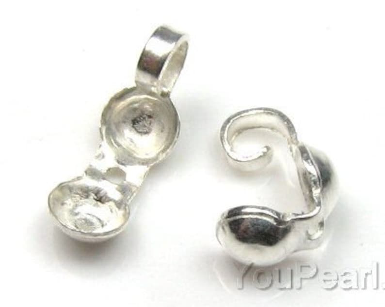 May include: Two silver-toned metal clasps for jewelry making. Each clasp has a round, smooth, and slightly domed shape.