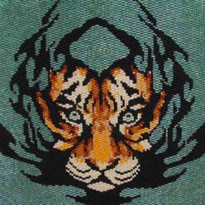 May include: A detailed needlepoint design of a tiger's face, featuring orange, white, and black colours. The tiger's face is centered against a teal background, with black tribal-style accents surrounding the face.