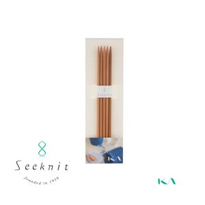May include: A package of eight Seeknit knitting needles. The needles are made of light brown wood and are bundled together with a white label that reads "8 Seeknit". The Seeknit logo and text "founded in 1916" are also visible.