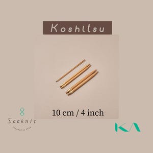 May include: Four wooden knitting needles with brass tips, and one smaller needle. The needles are 10 cm (4 inches) long. The image includes the text "Koshitsu" and "10 cm / 4 inch".