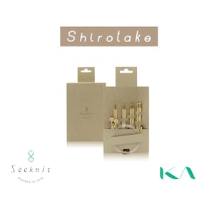 May include: A set of Shirotake circular knitting needles packaged in a light brown cardboard box. The set includes multiple bamboo needle tips with metallic connectors and a clear flexible cable. The brand name Seeknit and KA are visible.