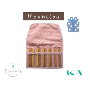 May include: A pink fabric case with a floral pattern, open to reveal a set of wooden knitting needles. The case has the text "Koshitsu" printed on the front.