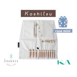 May include: A white canvas case with the text "Koshitsu case mini" printed on it. The case is open to reveal a set of knitting needles and a small pouch. The case is made by Seeknit, founded in 1916.