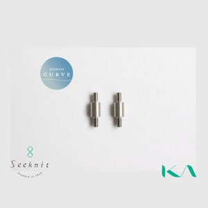 May include: Two silver metal knitting needle connectors with threaded ends. The connectors are cylindrical with a wider central section. The image includes the text "Seeknit Curve" and the Seeknit logo.