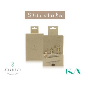 May include: A set of Shirotake knitting needles in tan cardboard packaging. The set includes multiple gold-toned metal needle tips of varying sizes and a clear circular cable. The brand name Seeknit is printed on the packaging.