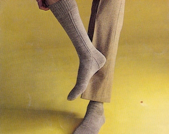 May include: A pair of gray socks with a ribbed pattern. The socks are being pulled up on a person's leg.