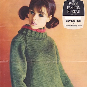 May include: A green knitted sweater with a turtleneck collar. The sweater is being modeled by a woman with a record album in her hand. The album cover features a band with the text "with the beatles".