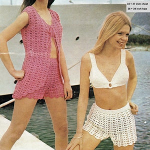 May include: Two women wearing crocheted bikini tops and shorts. The woman on the left is wearing a pink set, and the woman on the right is wearing a white set. The image includes the text "5295 DK 34 + 37 inch chest 36 + 39 inch hips".