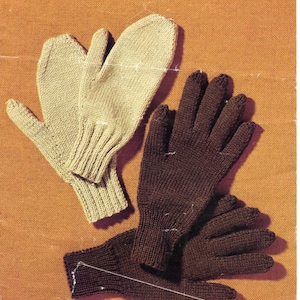 May include: Two pairs of knitted gloves, one pair is beige and the other is brown. The beige gloves are mittens and the brown gloves are fingered.