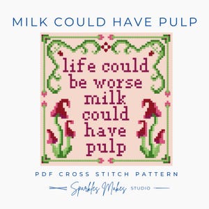 May include: A cross-stitch pattern with the text "life could be worse milk could have pulp" in dark pink. The design includes red mushrooms and green vines on a light pink background. The text "Milk Could Have Pulp" is at the top.