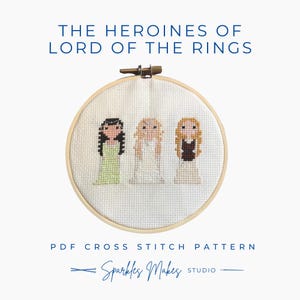 May include: A cross-stitch pattern featuring three female characters from Lord of the Rings, displayed in a wooden embroidery hoop. The text "THE HEROINES OF LORD OF THE RINGS" is at the top. The text "PDF CROSS STITCH PATTERN" and "Sparkles Makes Studio" are at the bottom.