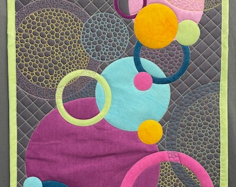 Colorful art quilt featuring Circles on a gray background