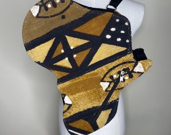 May include: A brown and black patterned fabric bag shaped like the continent of Africa. The bag has a zipper closure and a black strap.