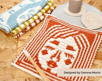 May include: A crochet pattern for a face cloth, featuring a stylized face with orange and white yarn. The pattern is titled "The Cloth Face" and is designed by Gemma Morris.