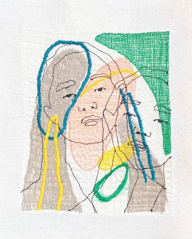 May include: Embroidered artwork featuring a stylized portrait of a person with overlapping lines and shapes in shades of gray, yellow, green, and blue.