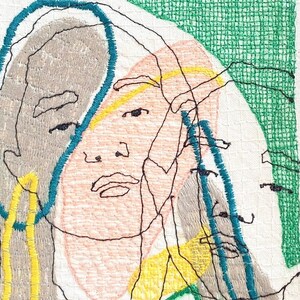 May include: Embroidered artwork featuring a stylized portrait of a person with multiple overlapping faces. The faces are outlined in black thread and filled with shades of pink, gray, and yellow. The background is a white fabric with a green grid pattern.