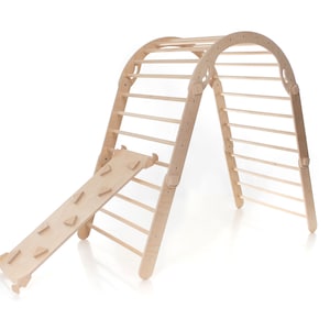 May include: A wooden climbing frame with a ladder and a slide. The frame is made of natural wood and has a curved top. The slide is attached to the bottom of the frame and has a series of small wooden steps.