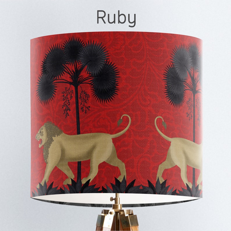 May include: Red lampshade with a black and gold lion design. The lampshade features a repeating pattern of stylised palm trees and a red background.