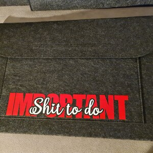 May include: A grey felt laptop sleeve with a red and white graphic that says "Important Shit to do".
