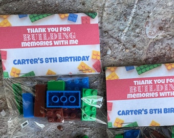 May include: Two small bags of colorful plastic building blocks with thank you tags that say "Thank you for building memories with me Carter's 8th Birthday."