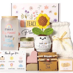 May include: A gift box for teachers, featuring a frosted glass tumbler with a rainbow and text, a crocheted sunflower, a candle, a plush item, bracelets, and a card. The box is decorated with floral designs and includes a variety of items to show appreciation.