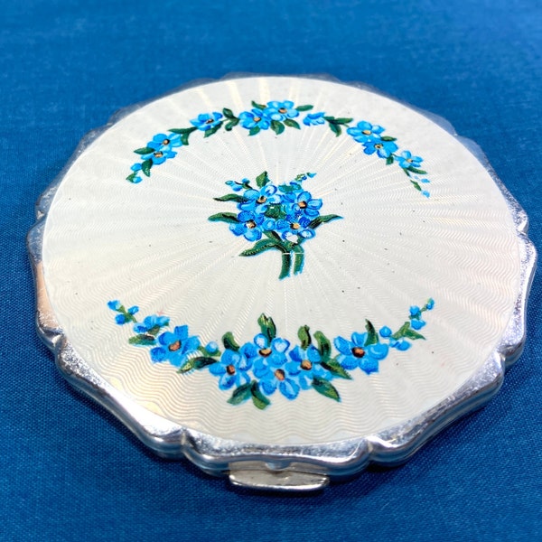 1950-60s Stratton Princess Compact, blue flowers on a white guilloche style; all-over star back; Powder well has auto open lid; Original tag