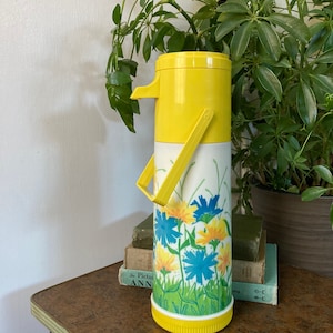 Floral yellow pump thermos.  B