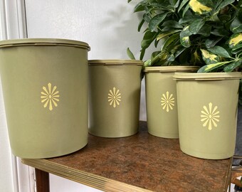 Four green Tupperware canisters
