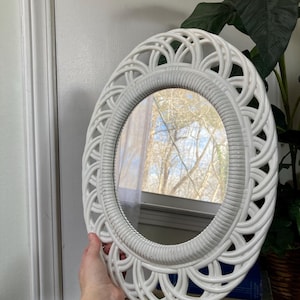 White plastic oval mirror