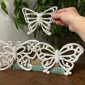 Three white wall butterflies