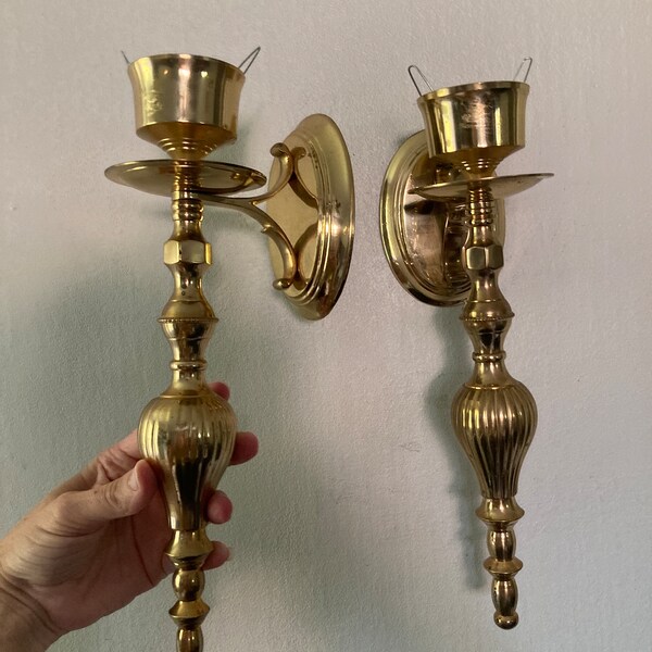 Shiny brass candle sconces