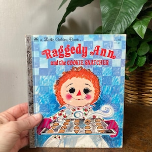 May include: A set of three ceramic mugs with a speckled, matte finish. The mugs are in shades of cream, light gray, and dark gray. Each mug has a simple, minimalist design, perfect for coffee or tea.